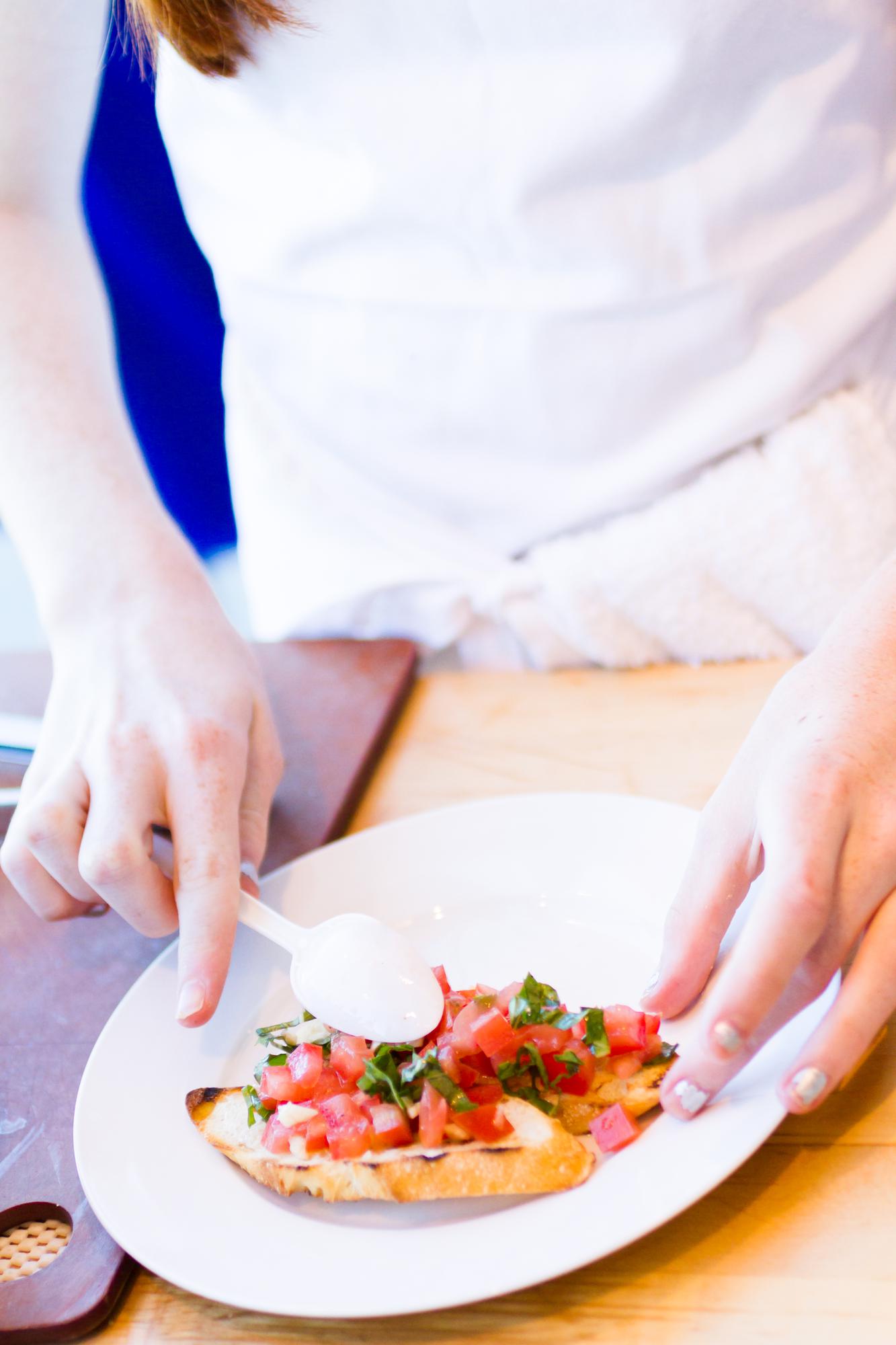 Chef plating a modern dish in a bright kitchen